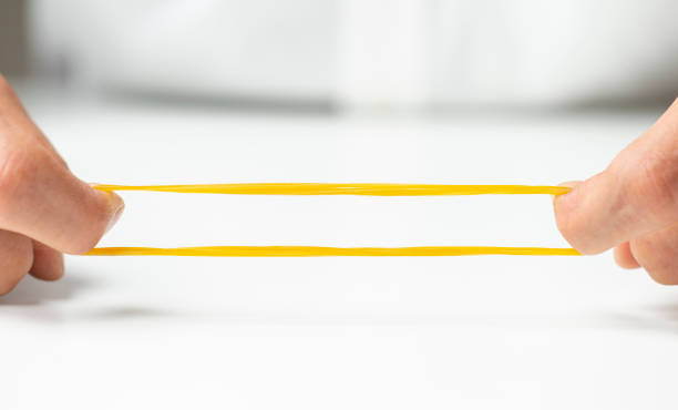 man pulling rubber band. close up.