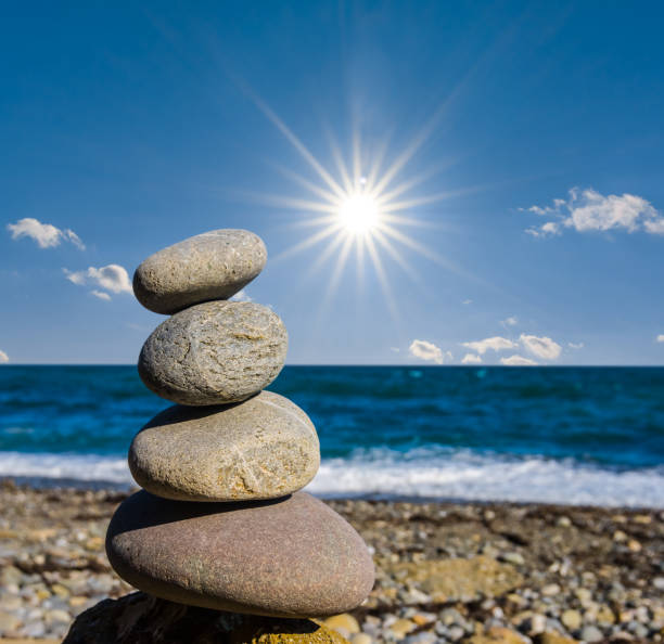 closeup heap of small stones on a sea beach under a sparkle sun